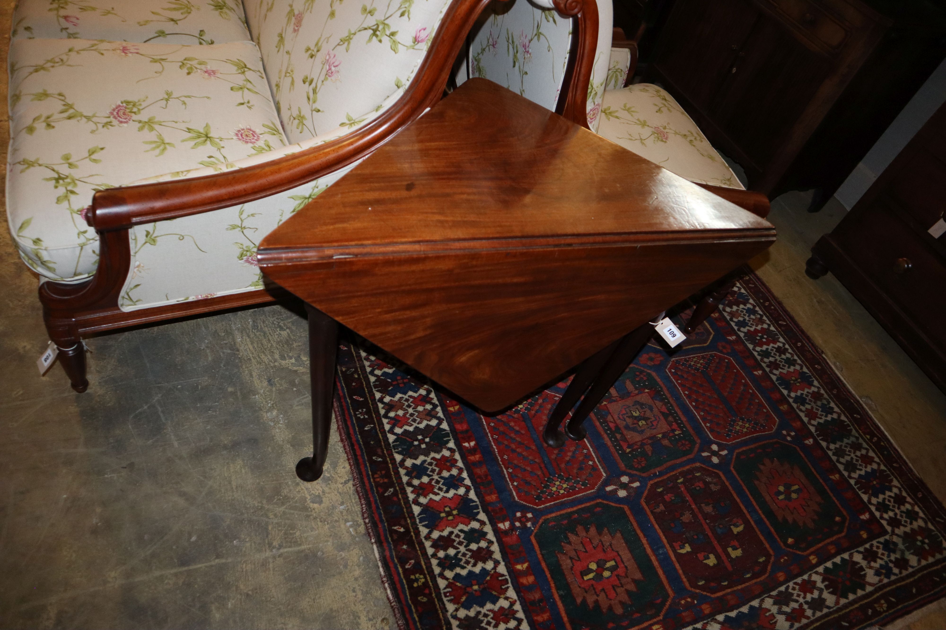 A George III mahogany triangular drop-leaf table, width 89cm, depth 46cm, height 72cm